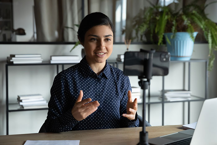 girl filming herself to watch back her public speaking mistakes