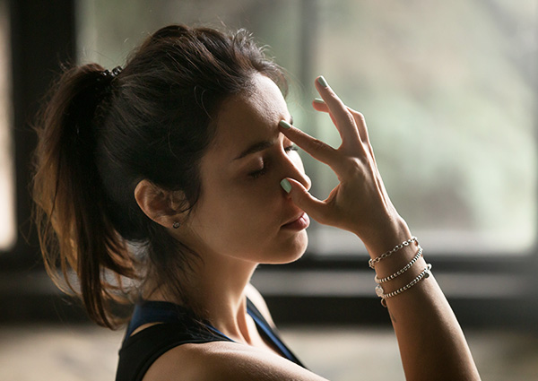 Woman doing breathing techniques to use in presentation.