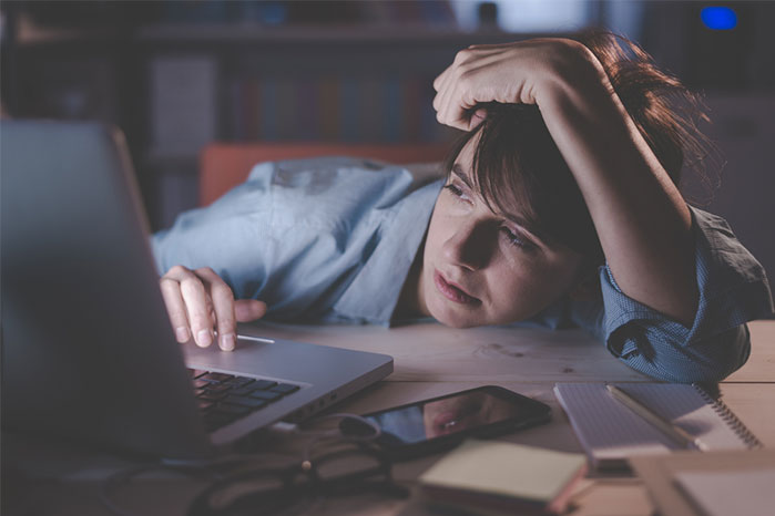 woman tired at laptop